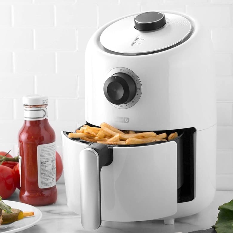 White compact air fryer with a drawer of french fries open