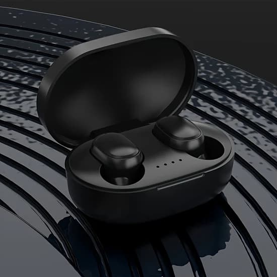 White wireless earbuds beside their charging case
